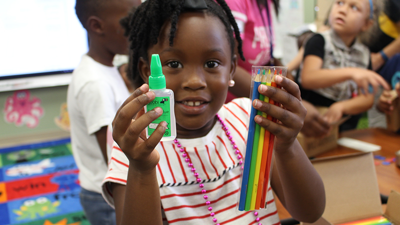 Student holding art supplies