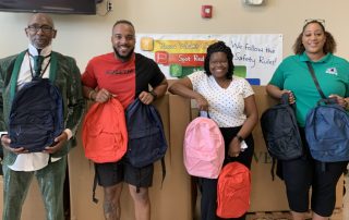 Teachers holding backpacks